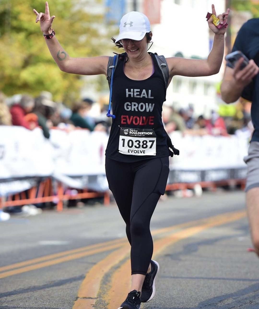 Dr. Carolyn Wojtusiak running the Boulder Marathon for Evolve Health and Wellness Chiropractic